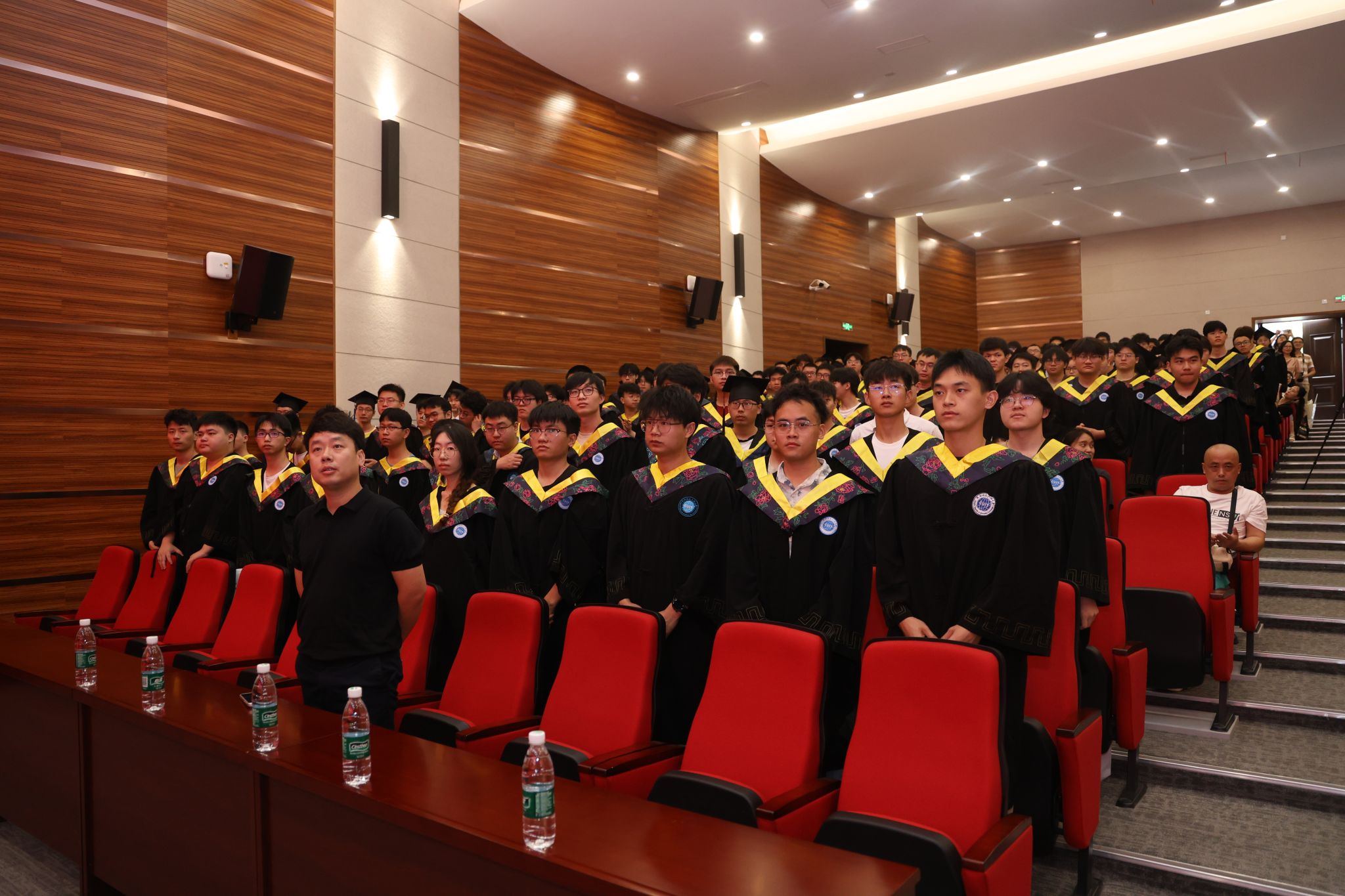 A group of people in graduation gowns AI-generated content may be incorrect.